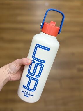 White FIFA World Cup CSD Water Bottle with Blue Logo and Coral Cap